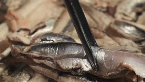 fresh sea sardines and anchovy fish and mullus on display on ice on market store shop. seafood fish background, close up stand of small salty white fish.