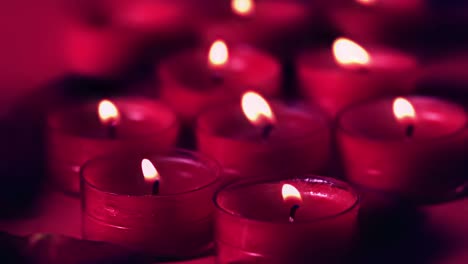 Animation-of-red-geometrical-shapes-over-red-candles