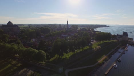 Aerial:-The-surroundings-and-the-historical-touristic-town-of-Veere,-the-Netherlands