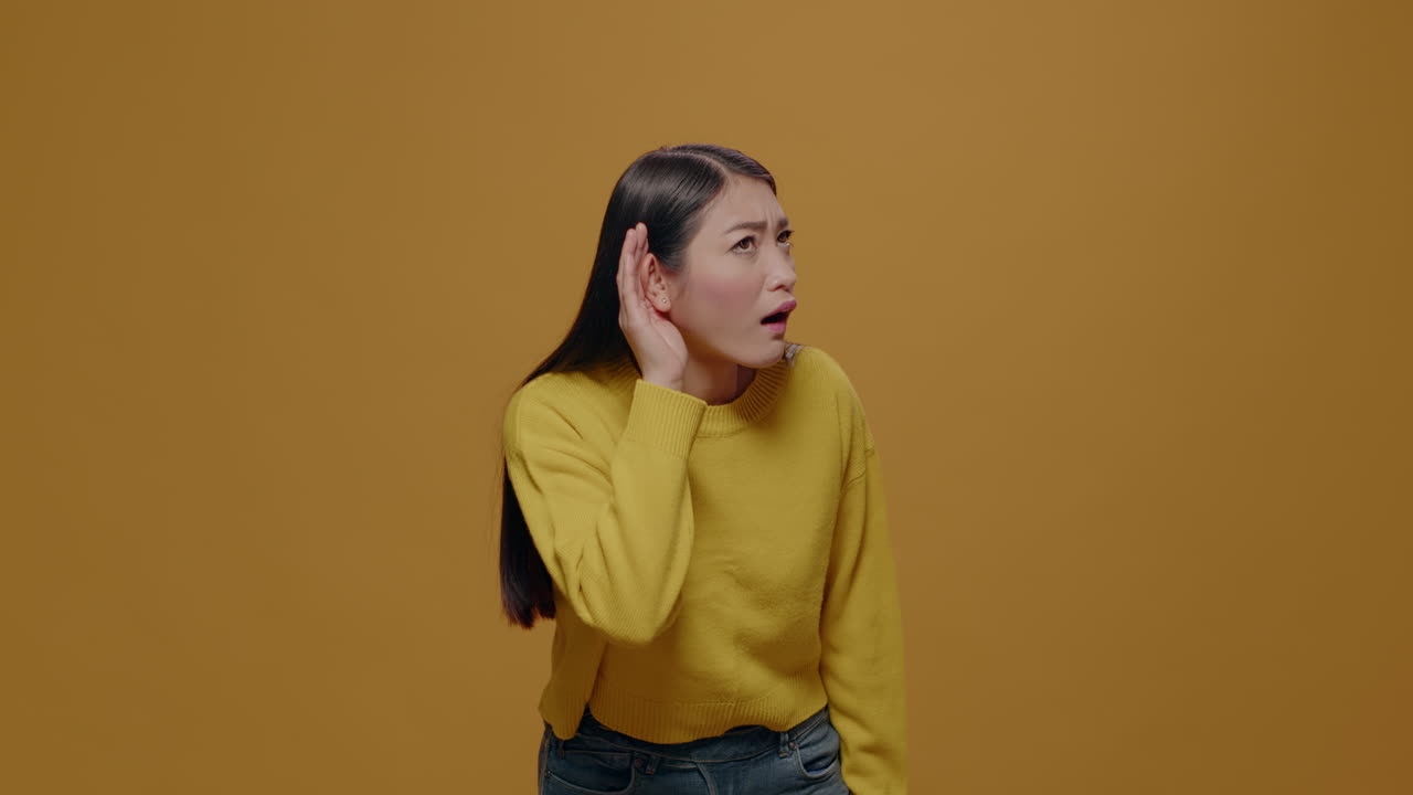 Portrait of woman eavesdropping discussion in studio