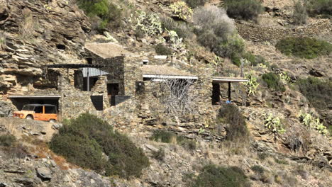 Expensive-stone-mansion-on-rocky-cliffs-in-Spain,-aerial-view