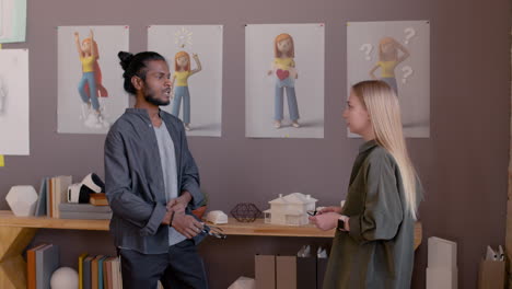 two multiethnic colleagues talking together in the office