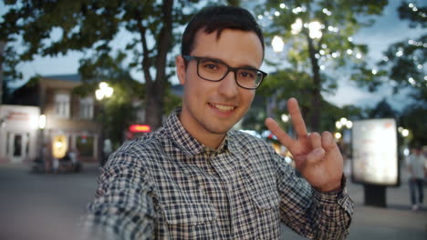 happy man taking selfie in the evening city