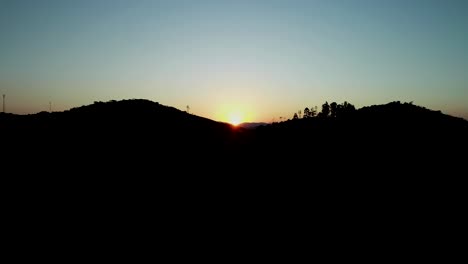 beautiful sunset filming with drone, sun descending in the middle of the mountain and beautiful light and vibrant colors