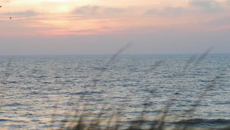 Romantic-sunset-in-to-the-sea-though-the-clouds