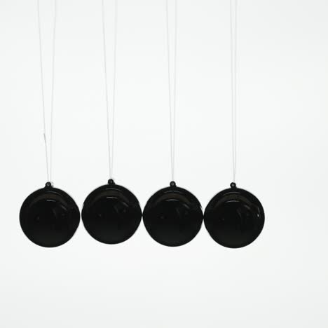 the silhouette of newton's cradle - a series of metal balls demonstrating the law of energy conservation