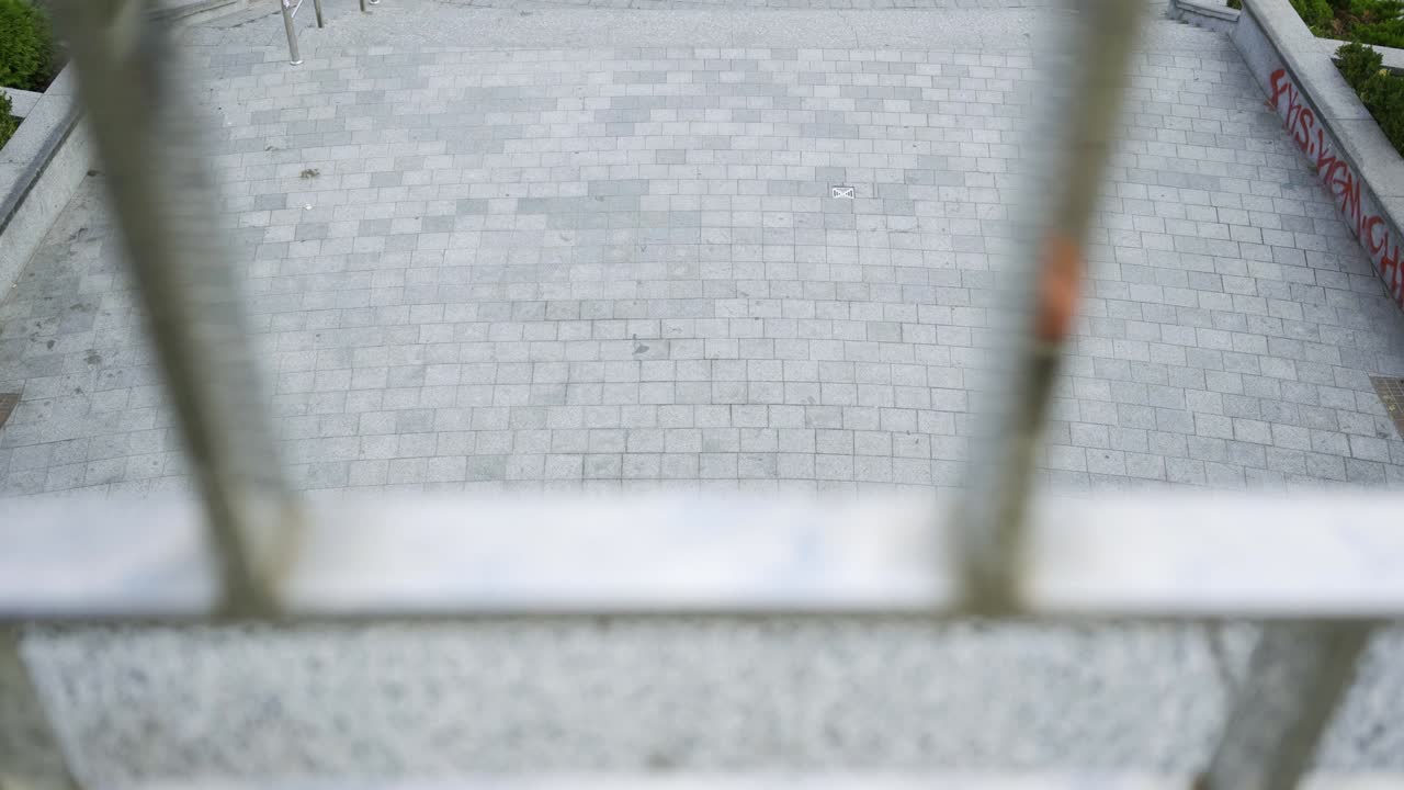 스케이트보드를 타고 서클을 타고 있는 한 다리를 가진 숙련된 젊은이의 최상위 시각.