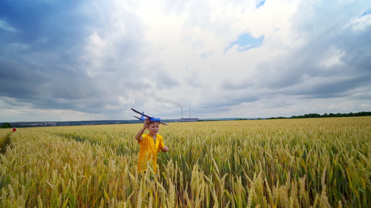 Running boy with toy plane. Happy child playing with toy plane on nature
