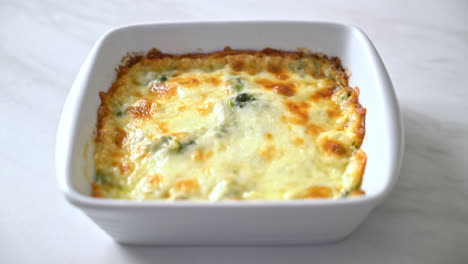 baked spinach lasagna with cheese in white plate