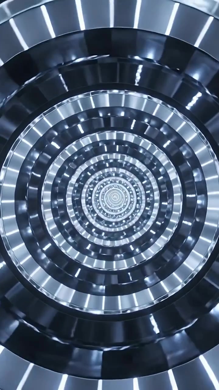 Video verticale: LED radiali pulsanti che iniziano a ruotare, con anelli concentrici che si muovono verso l'interno in una camera.