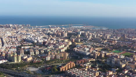 Buildings-residential-area-of-Malaga-aerial-view-mediterranean-sea-in-background