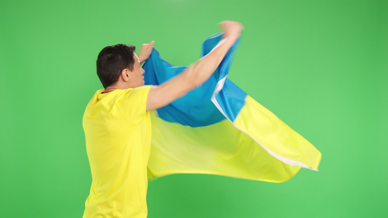 Ukrainian man with his back turned waving flag