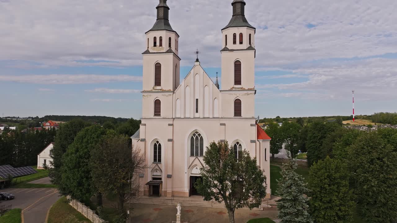 Drone establishing shot rising above Piatnica Poduchowna Catholic church, Poland