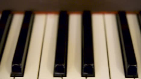 close of the black keys of a piano keyboard