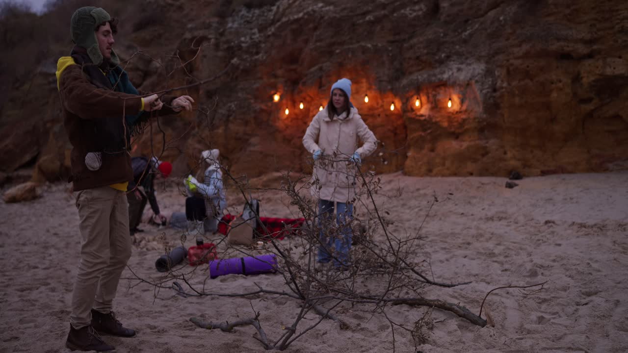 Friends gathering on the beach at sunset
