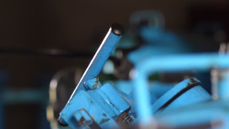 Close-Up-Of-Blue-Metal-Lever-In-Pump-Room