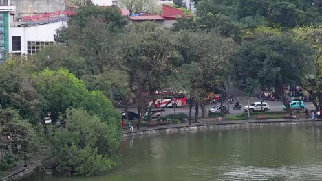 vehicles and trees by a serene lake