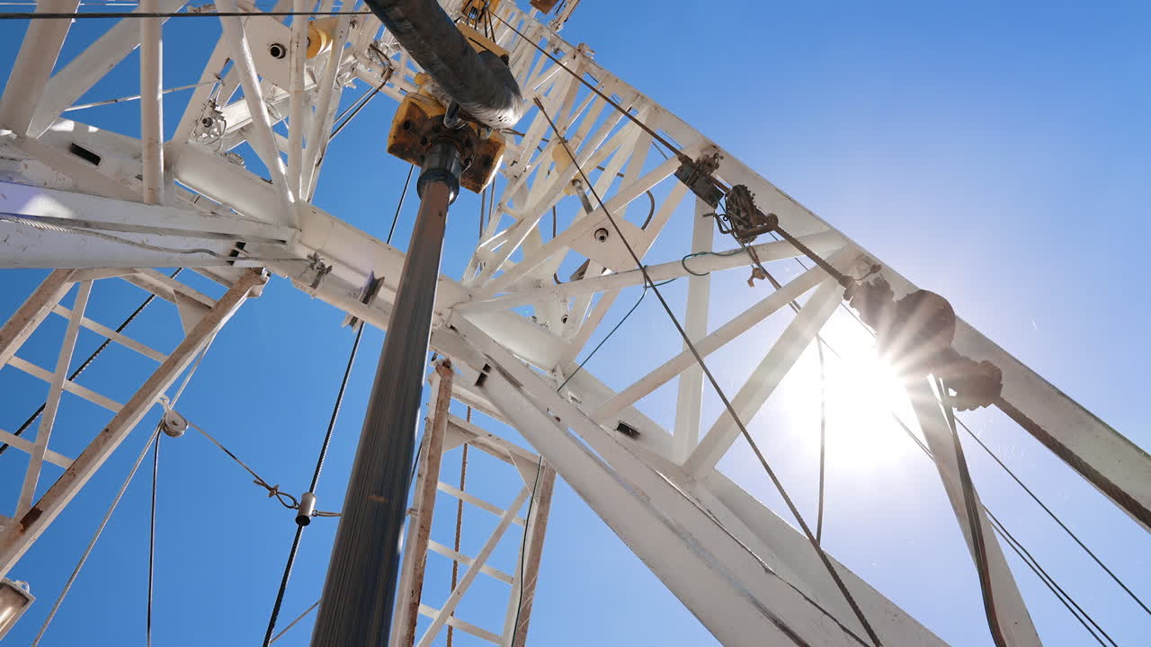 Rotary pole hanging from the derrick. Boer spins producing oil, gas or other natural resources.