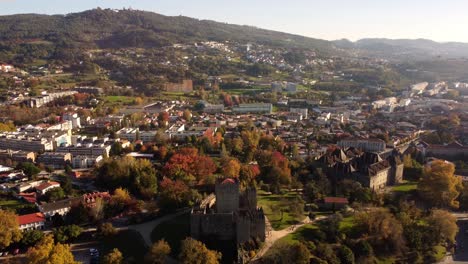 drone fly above guimares portugal old town during a sunny day with old medieval castle