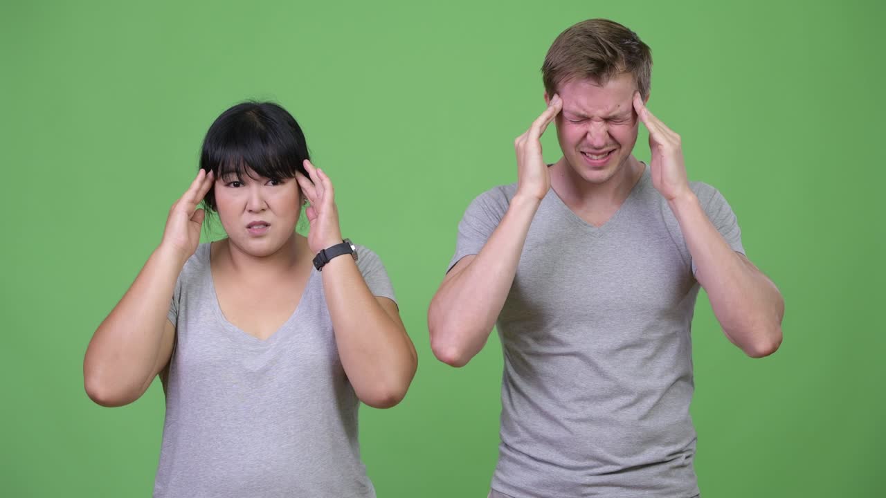 Young multi-ethnic couple having headache together