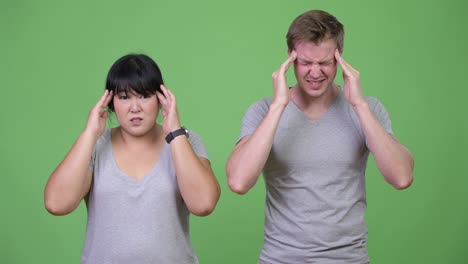 Young multi-ethnic couple having headache together