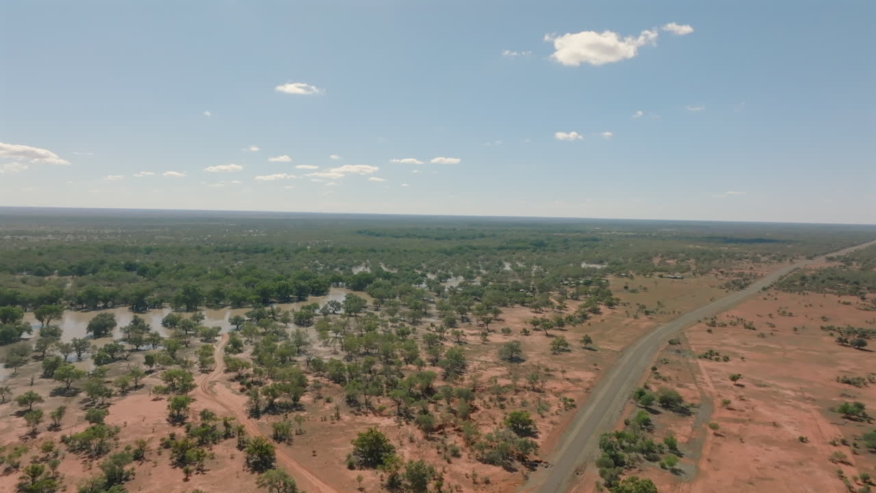 Aerial: Drone shot over the Australian outback and flooded bushland plains near Bourke, NSW, Australia