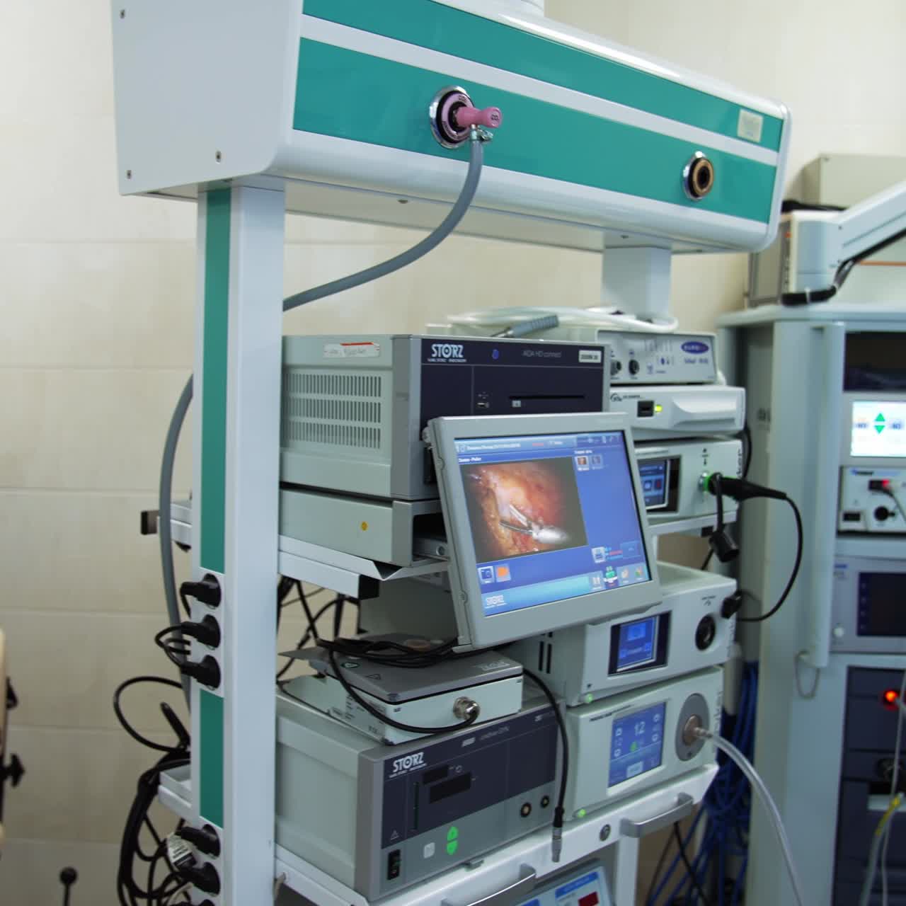 Screens in surgery room showing high-precise work of the robotic arm in patient's organ. Gradual motion to the Da Vinci robot not working at the moment