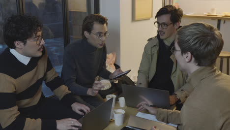 Businessmen-taking-break-in-cafe.-Colleagues-discussing-plans-of-new-project