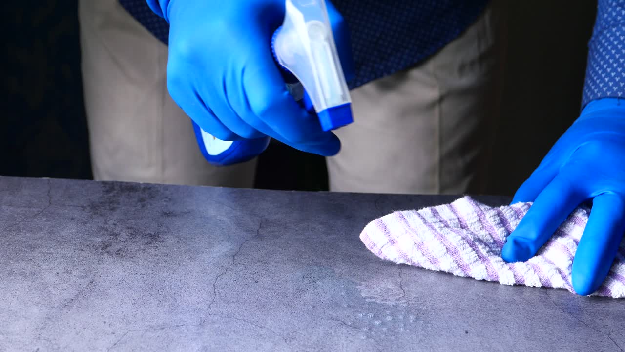 Cleaning a countertop with spray bottle and cloth