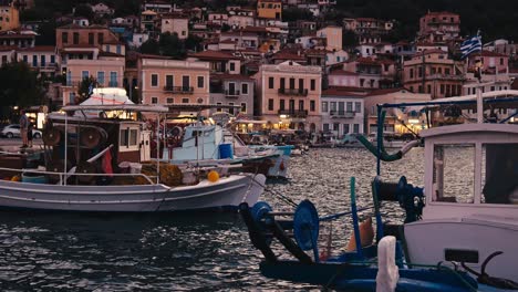Greek Fishing boats Portside in harbour waterfront evening golden hour