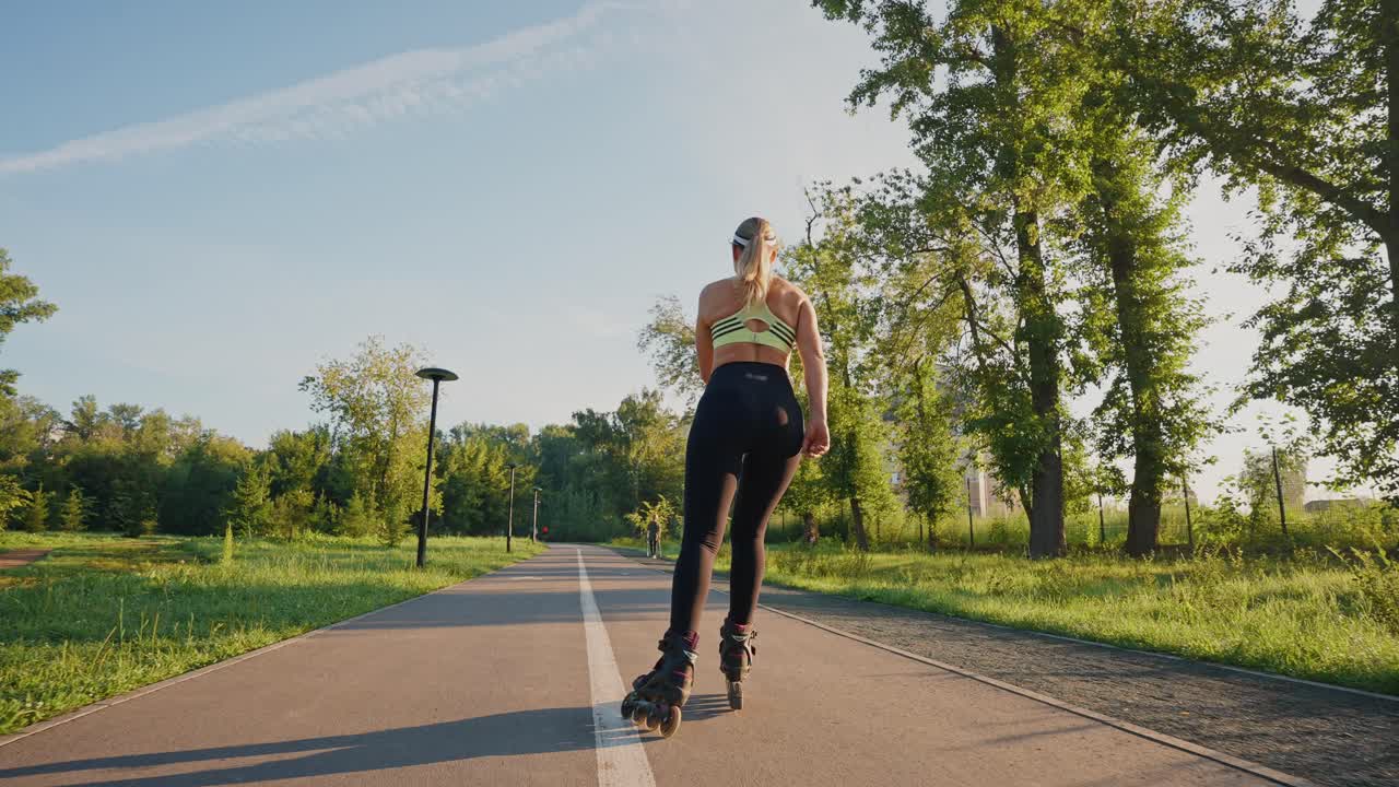 Woman Rollerblading in a Park at Sunrise