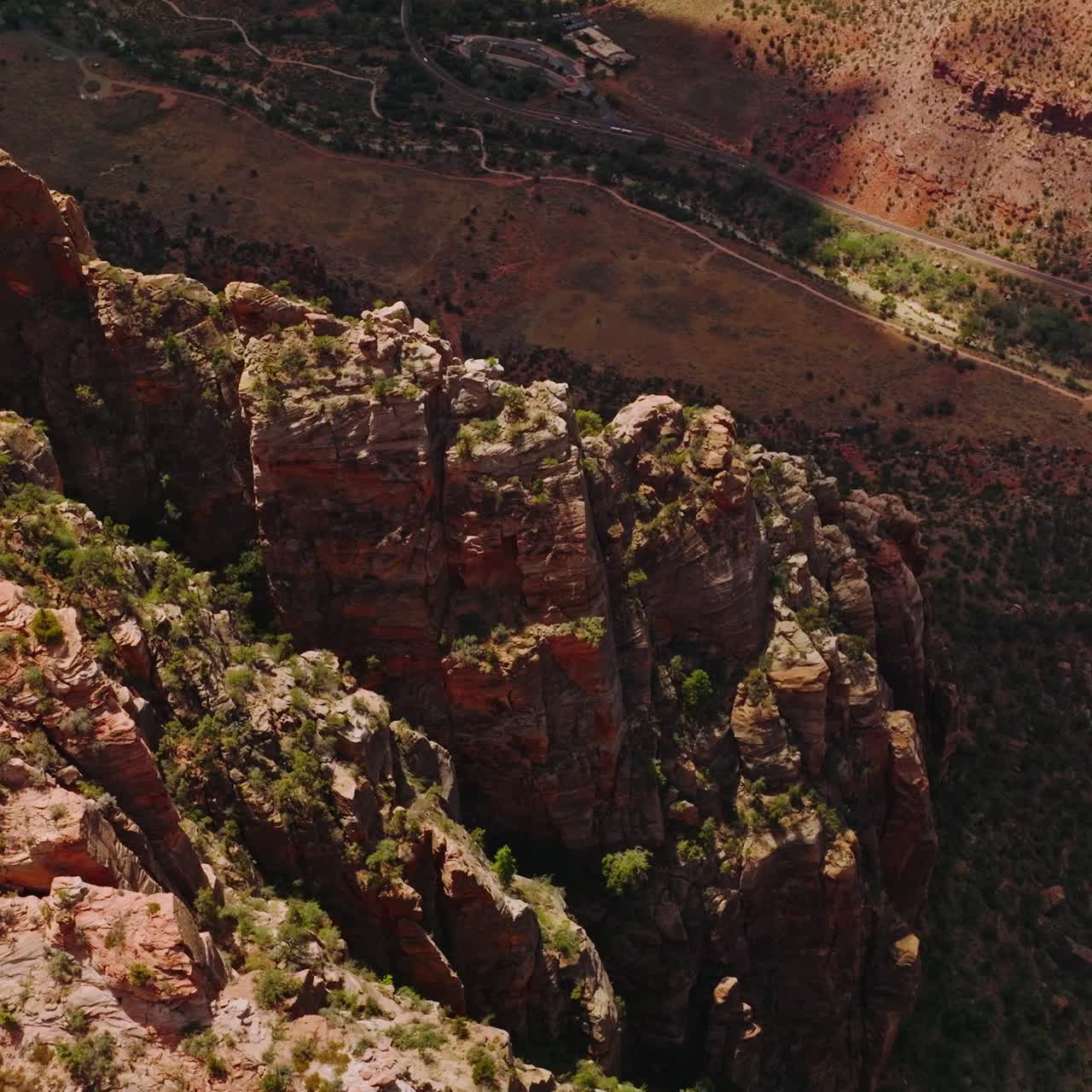 Looking at the tops of amazing canyons with little greenery. High sharp rocks towering over the desert in Utah, USA