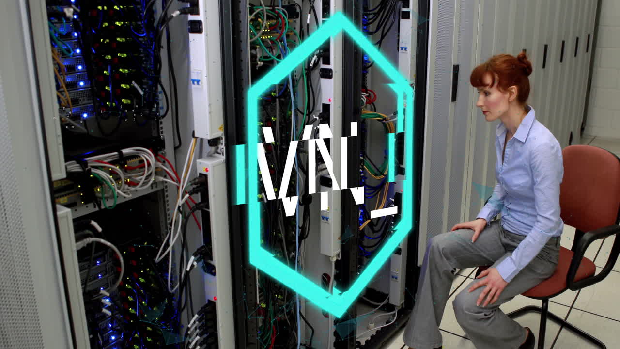 Sitting in server room, woman working on computer with TMJ logo animation