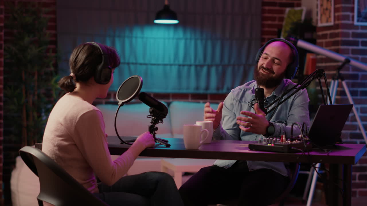 Man having casual converastion with woman in internet broadcast using professional microphone