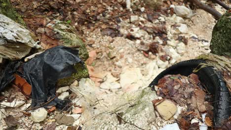 bad scenario with old waste and car tyre abandoned in the bed of a creek, environmental emergency concept