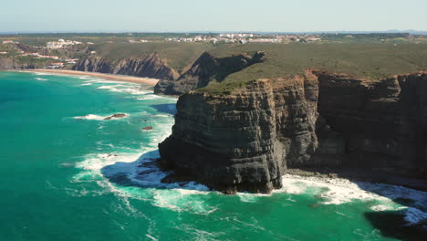 Aerial:-The-cliffs-near-the-town-of-Arrifana-in-Portugal