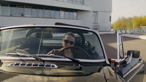 woman driving a classic convertible