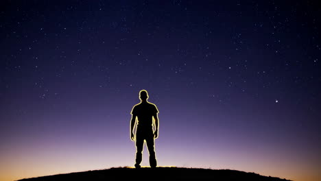 man silhouetted against the night sky