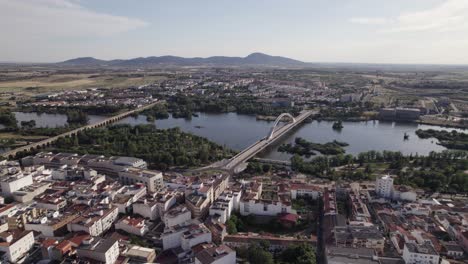 aerial view overlooking lusitania and puente romano bridges over guadiana river alongside the city and municipality of mérida, spain