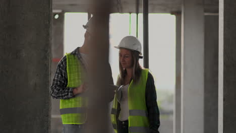 Construction-site-Team-or-architect-and-builder-or-worker-with-helmets-discuss-on-a-scaffold-construction-plan-or-blueprint-or-checklist