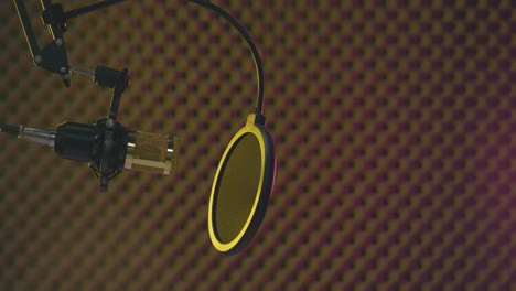 static view of a golden microphone in a smoke-filled professional recording studio