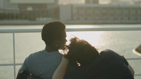 couple with disability sitting at quay, woman leaning head