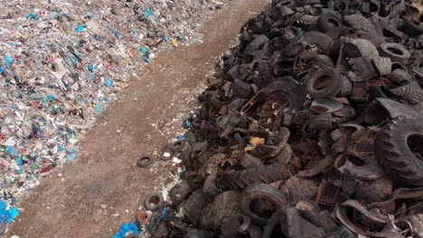 aerial pan over sorted garbage in a landfill