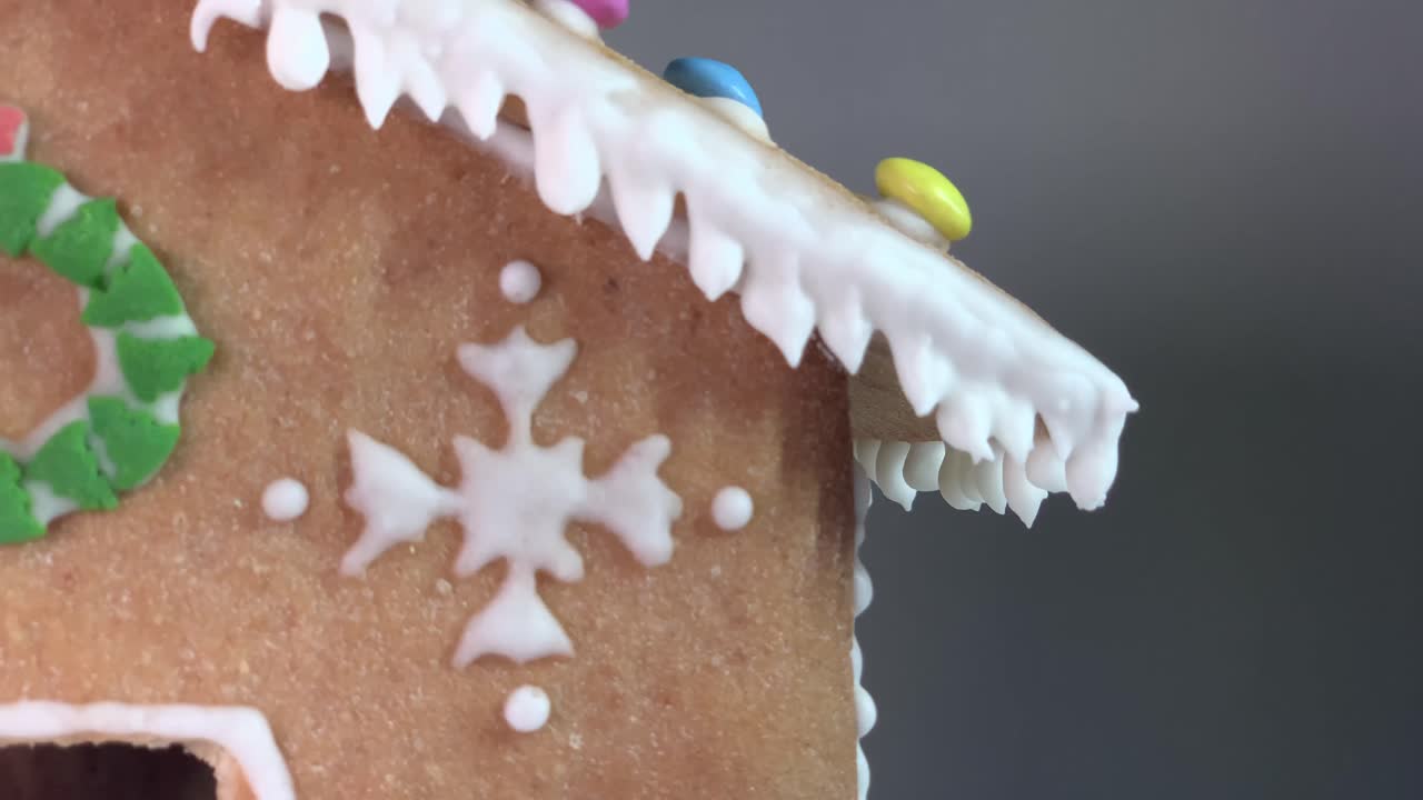 Chrismtas decorated gingerbread house over defocused light background