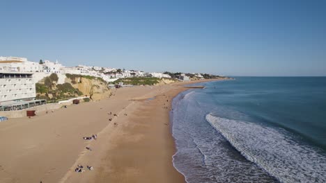 albufeira's sandy shoreline and cliffs. aerial fly-over