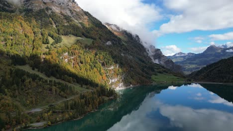 move along shot of klöntalersee glarus switzerland showing re crystal clear water and dense fforest trees