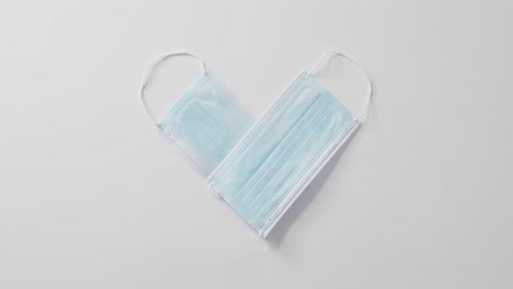 heart shape face masks on white background at valentine's day