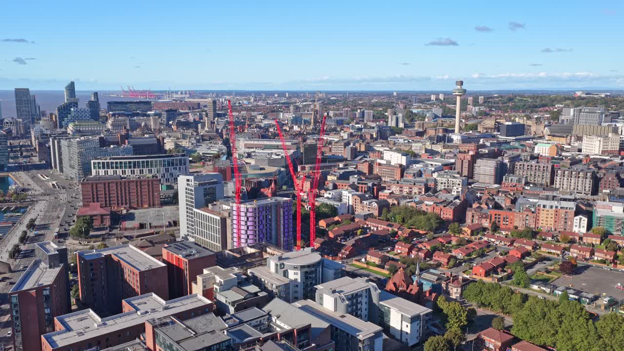 Stunning cinematic drone footage of Liverpool City Centre in northwest England, filmed during sunset., historic architecture, waterfront buildings, and urban atmosphere