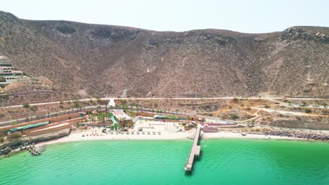 Drone footage of Playa Coromuel beach in La Paz with vibrant turquoise water and hills