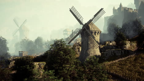 paisaje medieval nebuloso con molinos de viento y un castillo